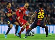 Barcelona's Adriano (L) and Alex Song try to stop Bayern Munich's Arjen Robben during their match on May 1, 2013